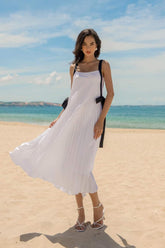 Flowy pleated silk dress with wide shoulder straps and bow-tie accents